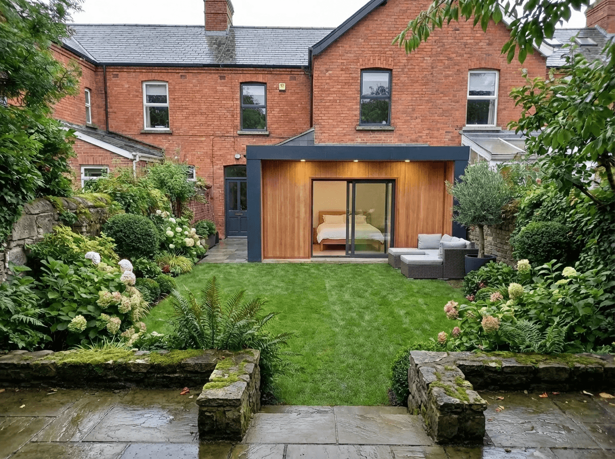 The Studio exterior — cedar cladding, garden setting, dusk light